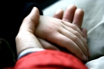 bigstock-Child-s-hand-resting-tenderly--18054611